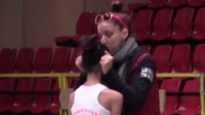 Треньорка дърпа ушите на гимнастичка